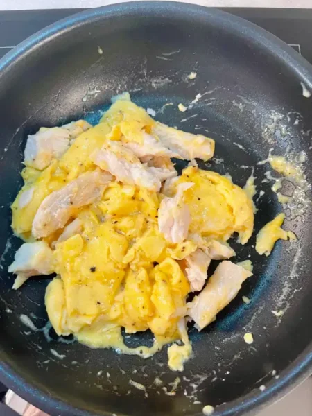 Plating the fish and scrambled eggs on toast