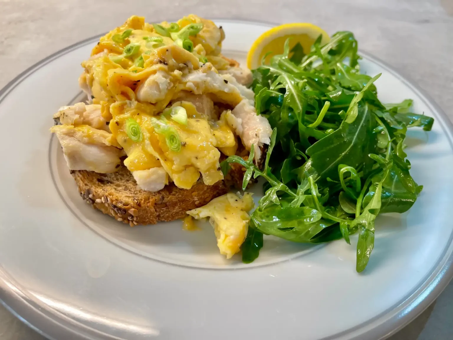 fish and scrambled eggs on toast